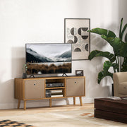 Brown TV stand holding a flat-screen TV in a living room beside a large leafy plant