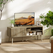Oak TV stand cabinet in a living room with a TV, plants and a cable box on the open shelf