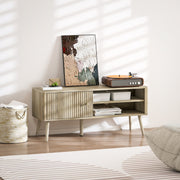 Oak TV stand cabinet styled with a record player and framed art in a living room