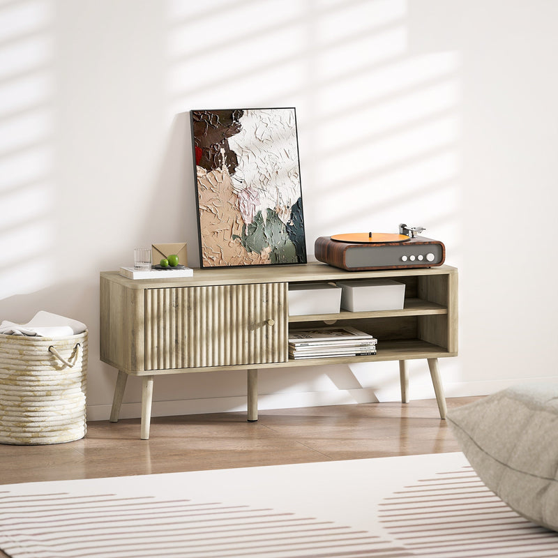 Oak TV stand cabinet styled with a record player and framed art in a living room