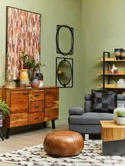 Square coffee table styled with books and a candle in a Japandi-style room