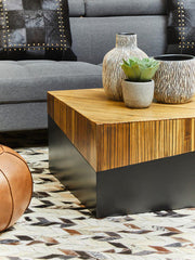 Lifestyle view of the bamboo coffee table with the dark base against a light floor