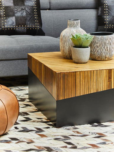 Lifestyle view of the bamboo coffee table with the dark base against a light floor