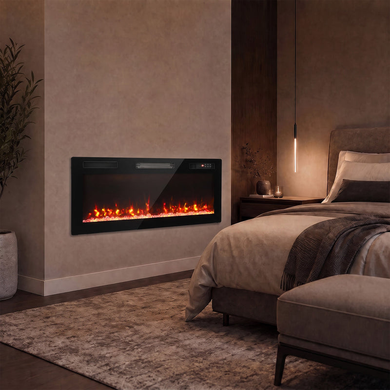Electric fire on a bedroom wall beside a bed in warm lighting