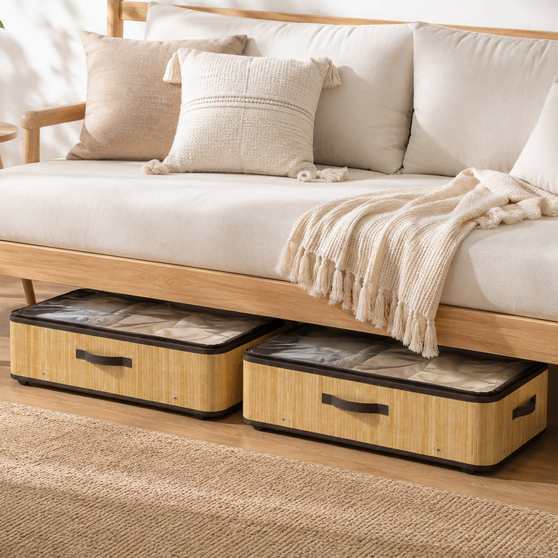 Two under bed storage boxes tucked beneath a beige sofa