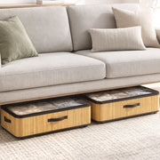 Two under bed storage boxes tucked beneath a grey sofa with cushions