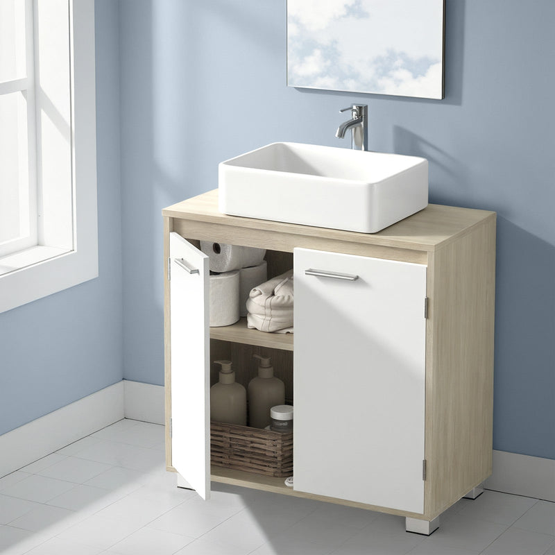 The cabinet in a blue bathroom below a square mirror, left door open with towels and toiletries inside
