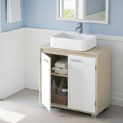 The cabinet in a blue and white panelled bathroom with a hanging towel and stacked towels on the shelf