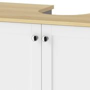 Close-up of the silver-tone round handles on the white cabinet doors