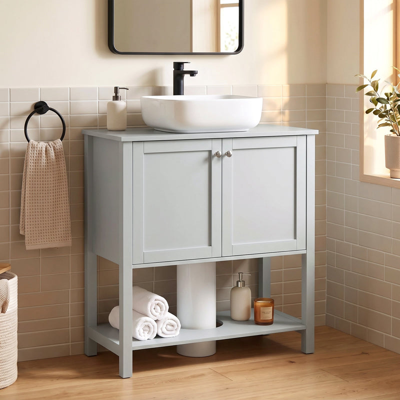 Light Blue under sink cabinet in a bathroom with a vessel sink, black tap and towel rail
