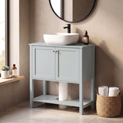 Light Blue under sink cabinet beside a window with a vessel sink and towels on the lower shelf
