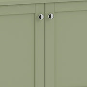 Close-up of the silver-tone round handles on the green cabinet doors