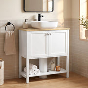 White under sink cabinet in a bathroom with a vessel sink, black tap and towel rail