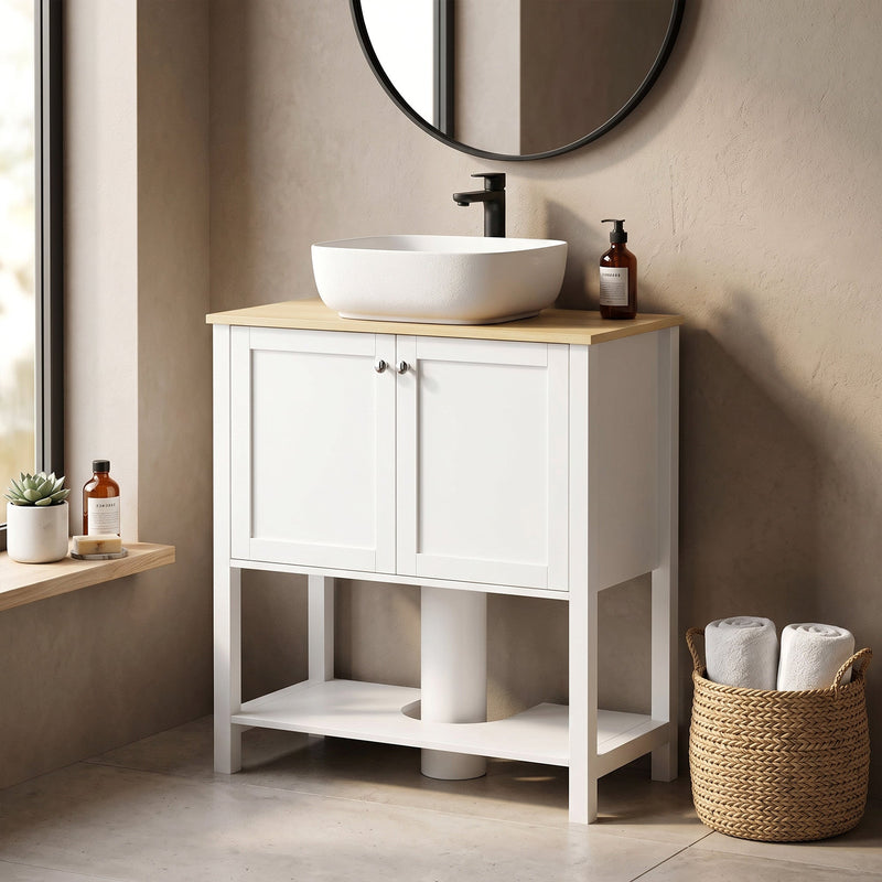White under sink cabinet beside a window with a vessel sink and towels on the lower shelf