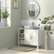 Cream under sink cabinet in a green and white bathroom with a round window mirror