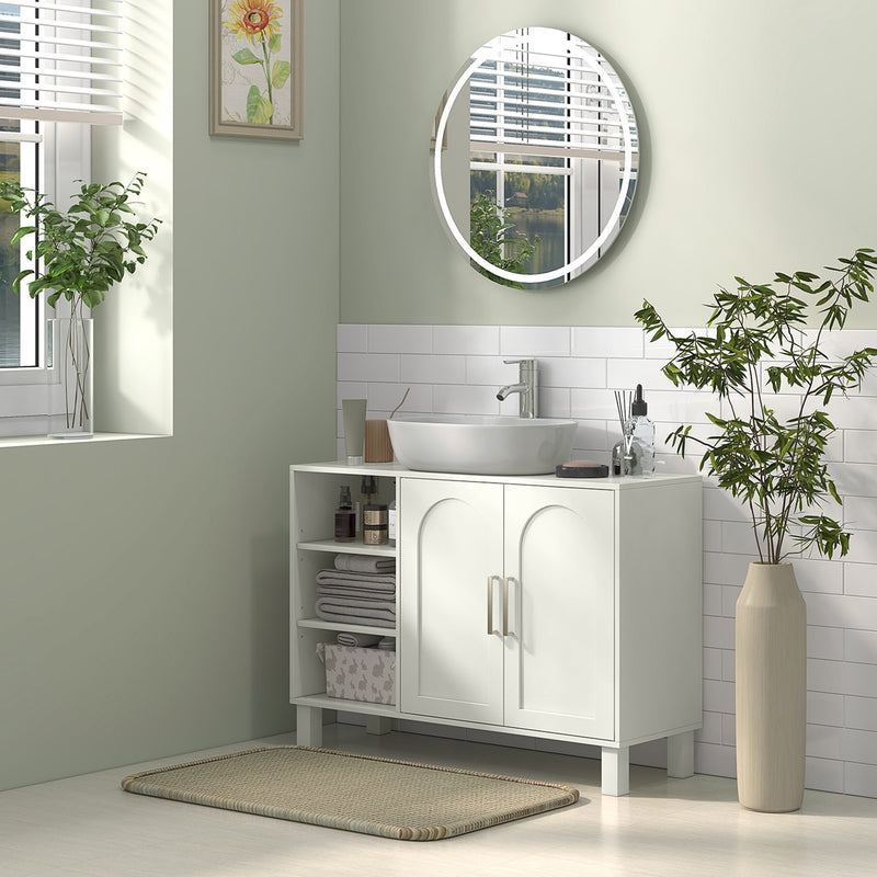 Cream under sink cabinet in a green and white bathroom with a round window mirror