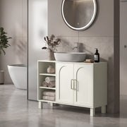 Cream under sink cabinet under a vessel sink with towels on the open side shelves