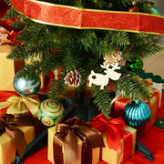 Close-up of the tree's lower branches with ribbon, baubles and a reindeer ornament above gift boxes