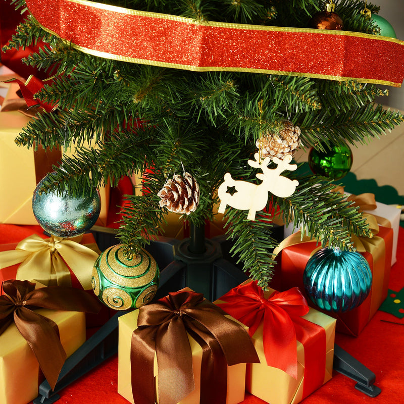 Close-up of the tree's lower branches with ribbon, baubles and a reindeer ornament above gift boxes
