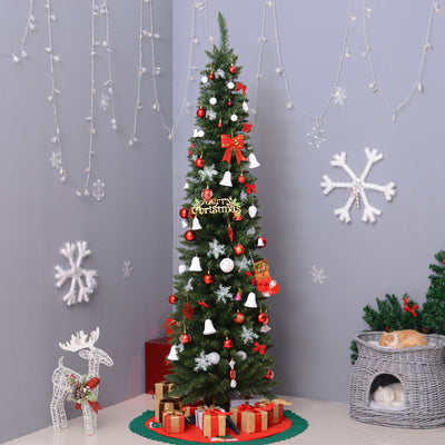 Decorated green pencil Christmas tree in a grey room corner with a wicker pet bed and gifts