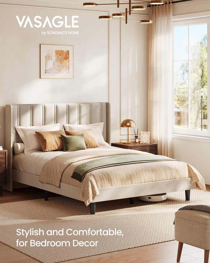 Vasagle cappuccino wingback bed dressed with cushions beside a bedside lamp