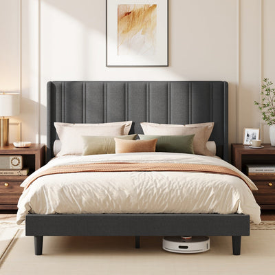 Slate grey upholstered king size bed with wingback headboard in a styled bedroom