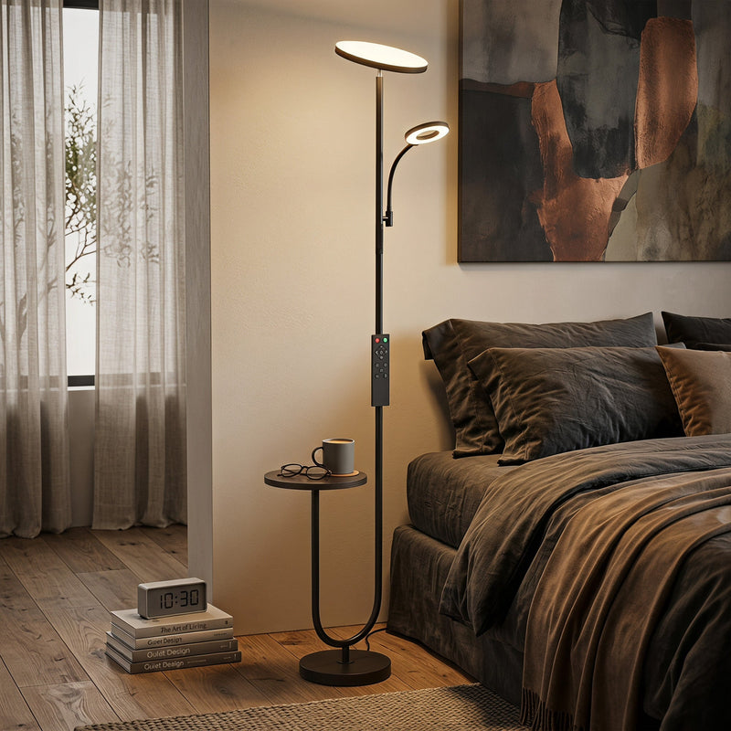 Floor lamp lit in a bedroom corner with the side table holding a mug and glasses