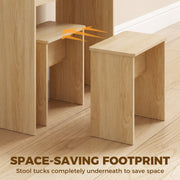 Oak stool tucked completely underneath the vanity desk to save floor space