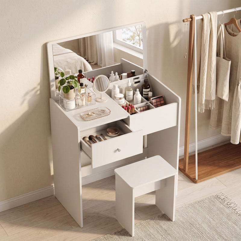 White vanity desk with makeup on top, drawer open and stool in a bedroom beside a clothes rail