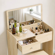 Close-up of the Oak vanity mirror, compartments and open drawer holding makeup palettes and skincare bottles