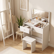 White vanity desk styled with cosmetics and the drawer open in a bedroom corner