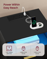 Close-up of the built-in charging station on the Vasagle Ink Black bedside table showing 2 AC outlets, USB-A and USB-C ports