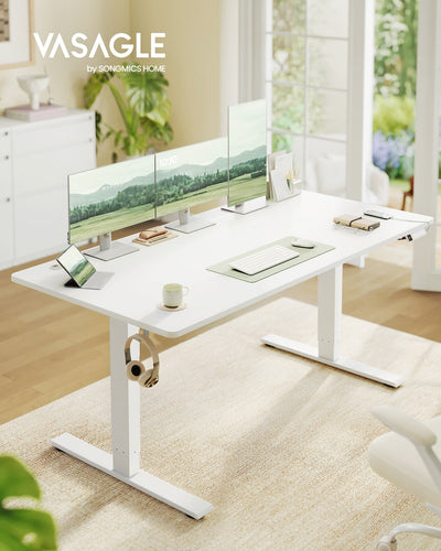 Matte white Vasagle standing desk styled in a home office with plants and natural light