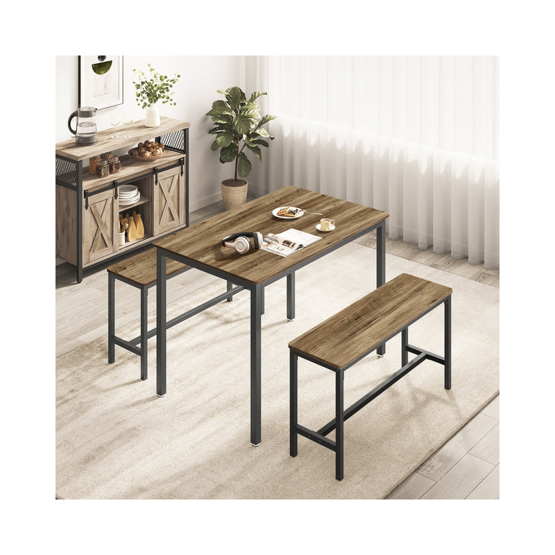 Dining table and benches in a dining room beside a sideboard