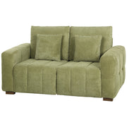 Green velvet 2 seater sofa with two pillows and wooden legs, front view on white