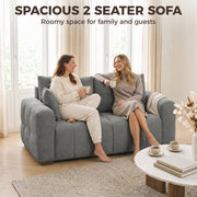 Two women chatting on a grey 2 seater sofa under the heading spacious 2 seater sofa