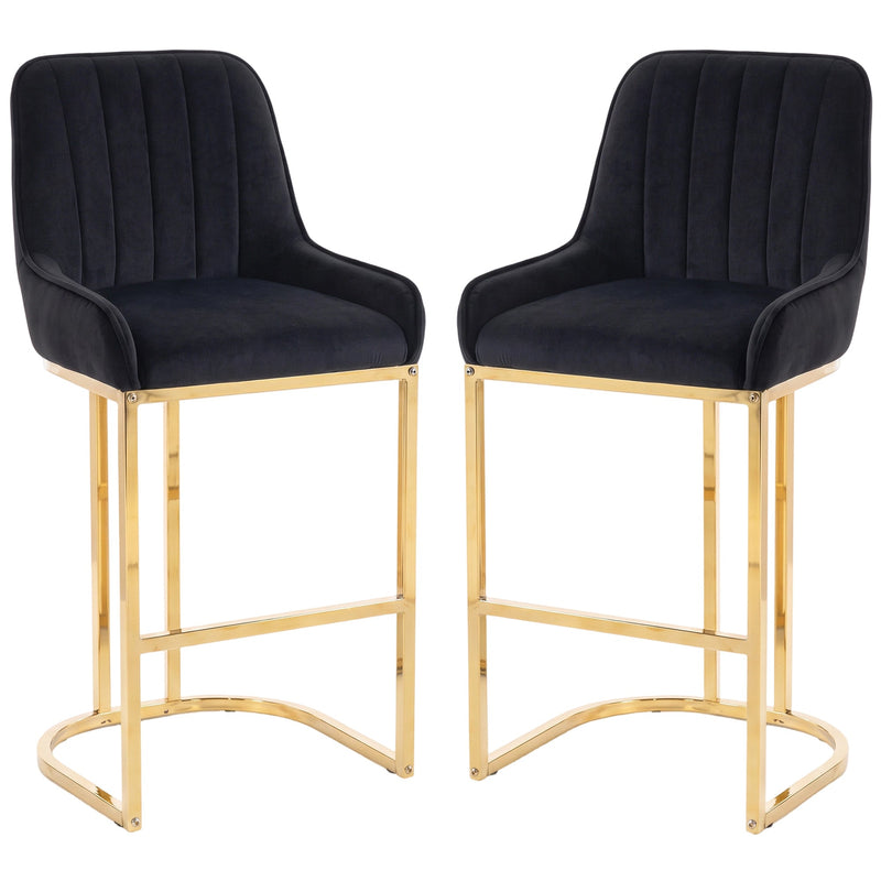 Set of 2 black velvet bar stools with gold legs on a white background