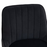 Close-up of the pleated black velvet backrest and seat cushion
