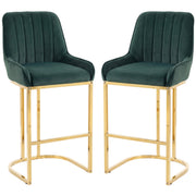 Set of 2 dark green velvet bar stools with gold legs on a white background