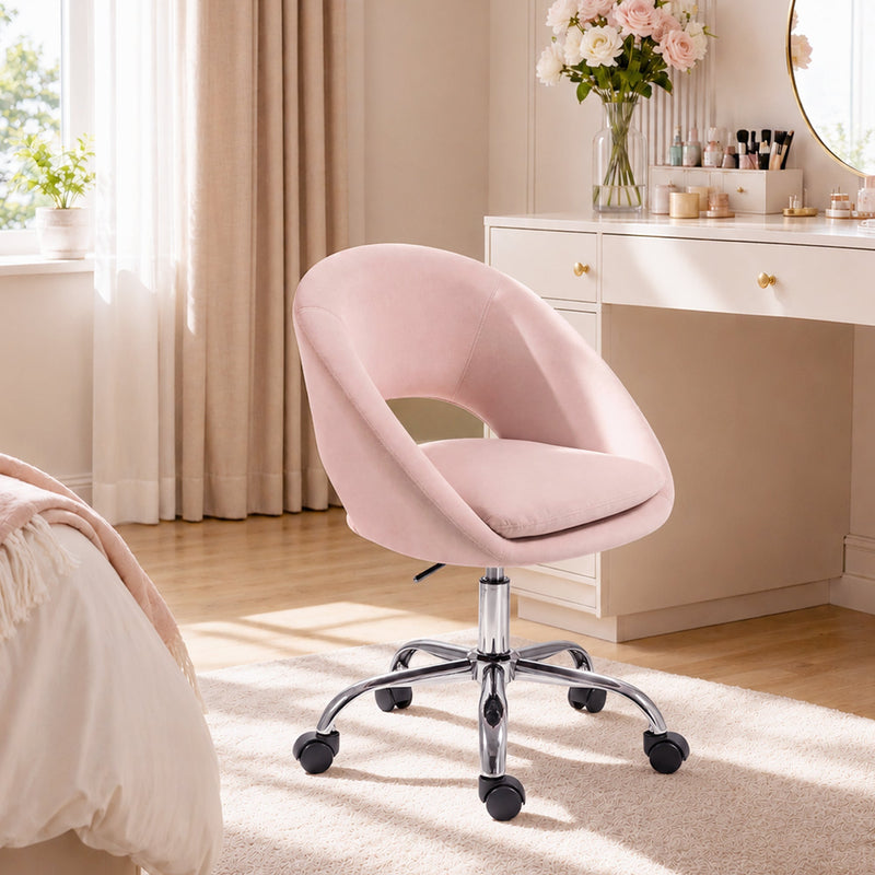 Pink velvet desk chair shown from the back, showing the rounded barrel-style backrest