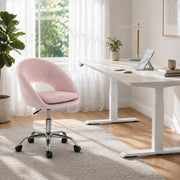 Pink velvet desk chair shown at a low seat height setting