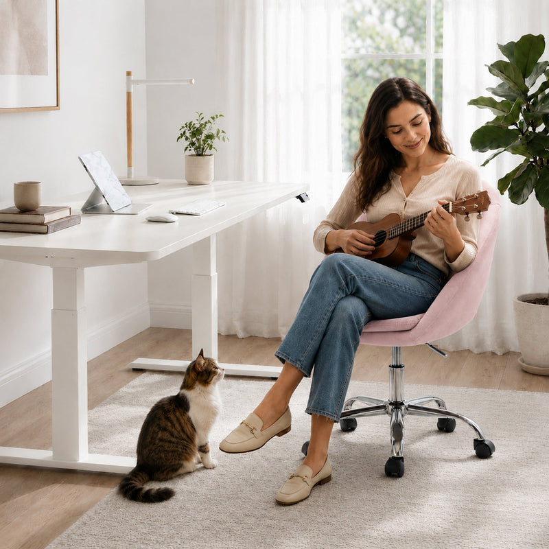Pink velvet desk chair shown at a raised seat height setting