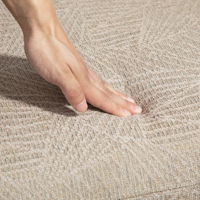 Hand pressing into the soft velvet-feel khaki fabric