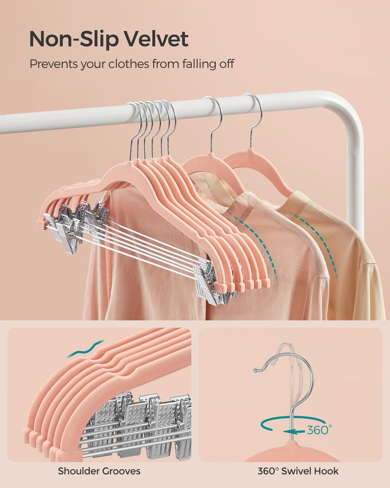 Row of light pink velvet hangers with shoulder grooves and 360 degree swivel hooks