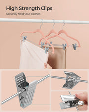 Close-up of the high strength metal clips gripping trousers on pink hangers
