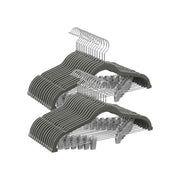 Stacked grey velvet trouser hangers with metal clips and chrome hooks