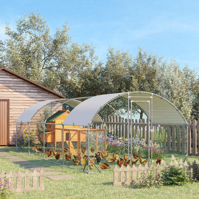 Lifestyle render of the coop in a garden with chickens roaming inside, a wooden hen house is shown as a styling prop and is not included