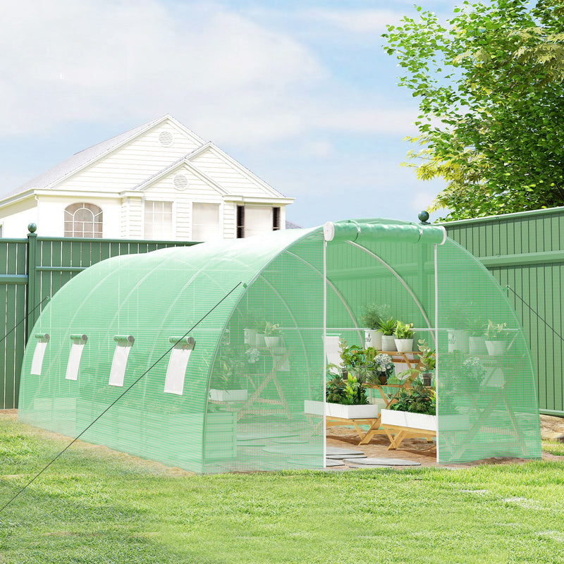 Polytunnel on a lawn with the door open and potted plants visible through the cover
