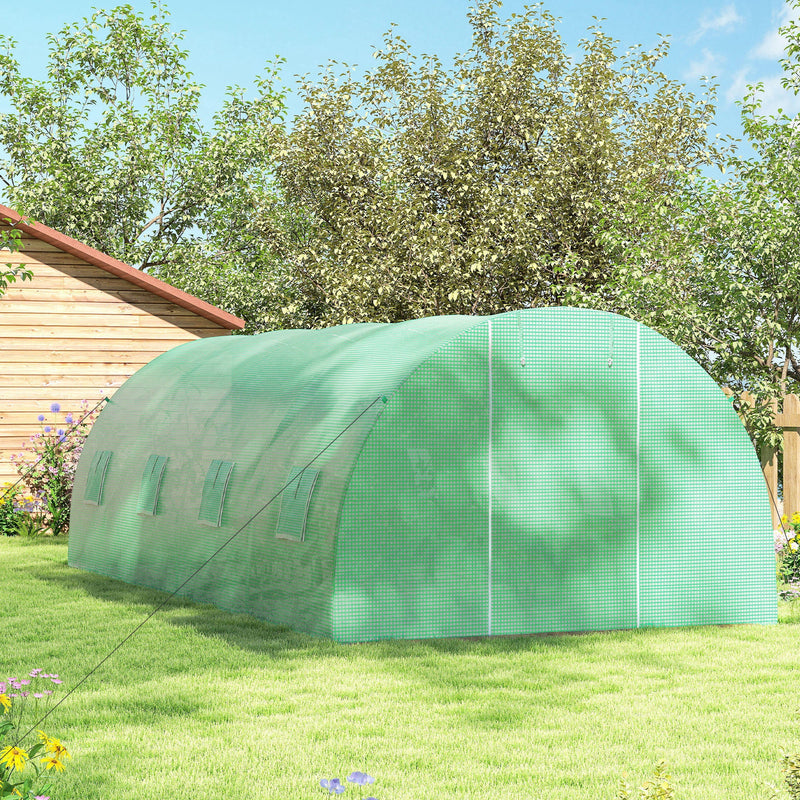Side view of the polytunnel greenhouse on a lawn with mesh windows along the cover