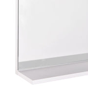 Close-up of the mirror's bottom shelf ledge and glass edge finish